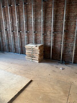 Metal Wall Framing and old wooden pallets with  Exposed Brick Wall Inside Building Under Construction 