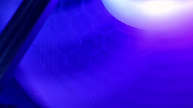 Fans of a modern computer spinning illuminated by LED lights and creating a blue hexagonal pattern