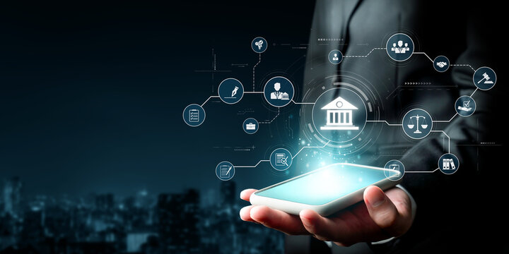 A businessman holds a smartphone displaying a glowing digital banking interface featuring icons related to law and regulations, symbolizing online financial services. XDMCP