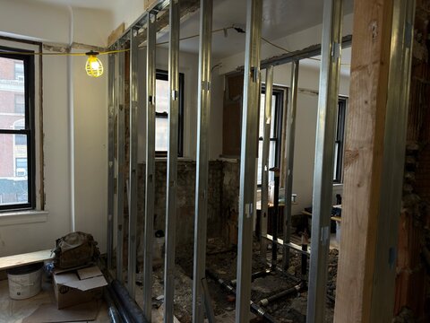 Metal Stud Framing and Plumbing Installation During Interior Building Renovation