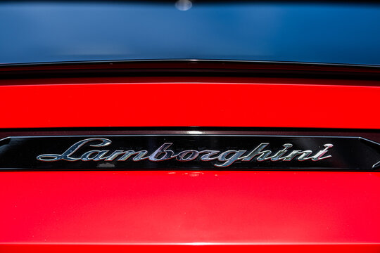 Gothenburg, Sweden - september 07 2024: Closeup of chrome Lamborghini emblem on glossy red body panel.