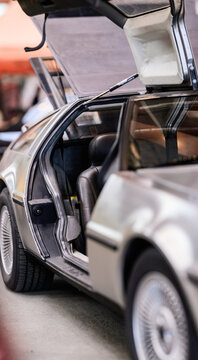 Gothenburg, Sweden - May 30 2026: Open gullwing door detail on stainless steel DeLorean DMC12.