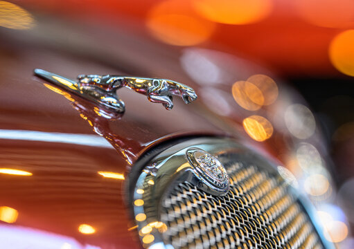 Gothenburg, Sweden - May 30 2026: Chrome Jaguar hood ornament above classic grille with bokeh.