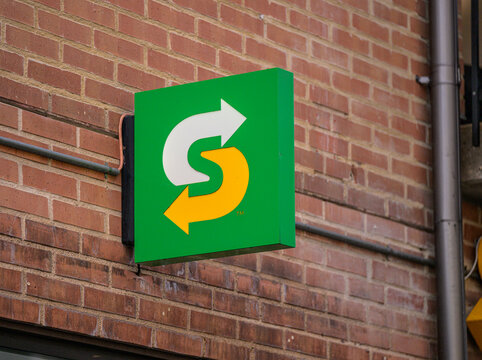 Gothenburg, Sweden - June 04 2026: Subway restaurant arrow logo sign on brick wall exterior.