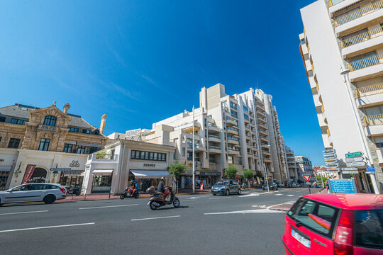 San Sebastian, Spain - July 28 2016: Sunny urban boulevard with modern apartments and luxury storefronts.