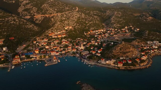 Tranquil drone panorama of a tiny Croatian fishing village at golden hour