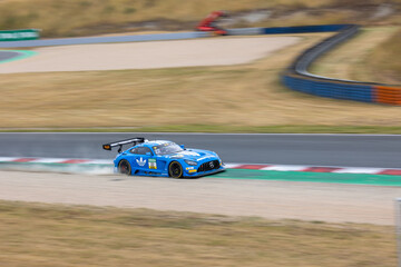 Obraz premium Oschersleben, Germany. 26th July 2026. Lucas Auer runs wide in blue number 22 Mercedes-AMG GT3 from Team Landgraf at Motorsport Arena Oschersleben during DTM 2026 race. 