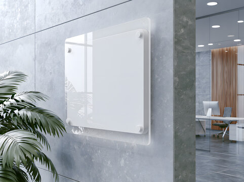 a mockup of a blank white acrylic sign mounted on an office wall, ideal for a corporate lobby, with a blank surface where you can display a company's identity