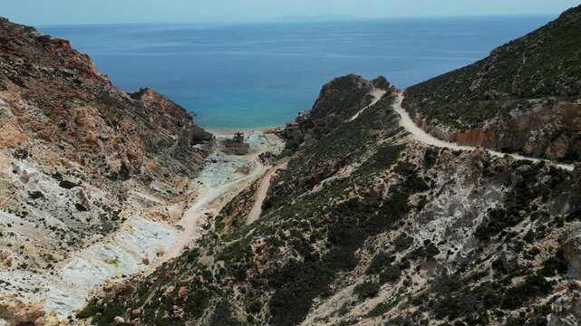 Flying down the ridge towards the Old Slufur Mines Thiorichia, Milos, Greece. Shot on a 4k at 60 fps on a DJI Mini 3 Pro in D-Log Film Colorgraded