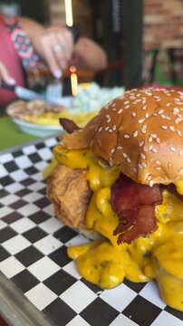 Close up of loaded cheeseburger with melted cheese and bacon