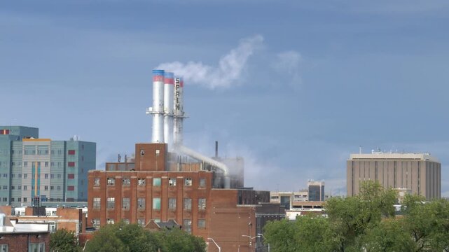 View of Detroit Thermal steam energy utility, historic Willis Avenue Station in Midtown Detroit, Michigan and steam rising from the stacks. Shot on a sunny afternoon in September 2022.