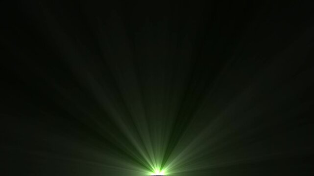 Abstract green light rays burst or dramatic sunburst flare on dark black background