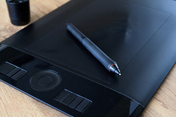 Digital stylus on a black graphics tablet for digital drawing. Digital illustration process and creativity © yaviki