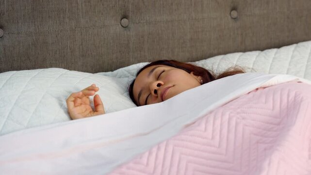 Young woman sleeping peacefully in her bed