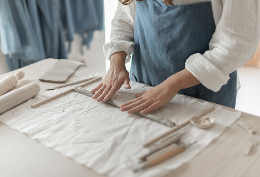 Potter artist forming clay in a focused and creative ceramic studio