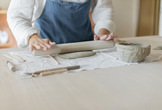 Potter artist forming clay in a focused and creative ceramic studio