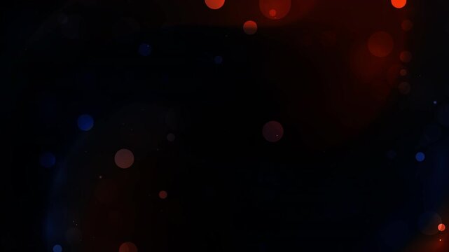 Abstract bokeh circles with red and blue hues on dark background ideal for design projects needing dynamic energy.