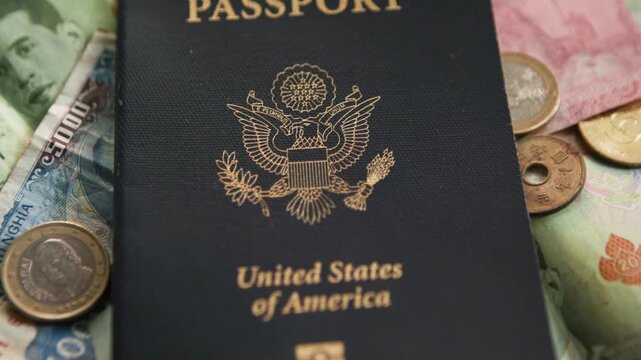 American Passport close up surrounded by foreign currency