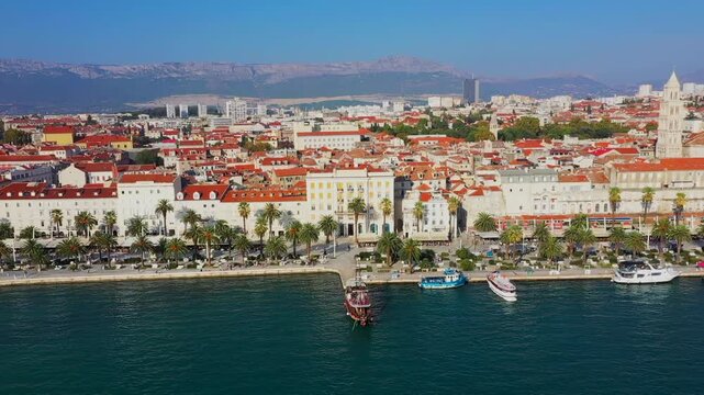 Aerial film of the coast of Split, Croatia, a historic place with old houses and castles on the seafront in Europe