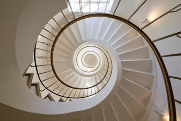 Fototapeta premium Elegant Modern Spiral Staircase Interior with Natural Light
