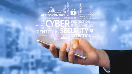 Obraz premium A close-up of a hand holding a smartphone amid a visual representation of cyber security terms, conveying the importance of protecting digital identities and data privacy. Tessel