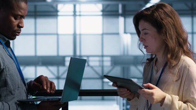 Technicians use digital tools in a server farm to analyze infrastructure data and check system integrity, combining infrastructure analysis, system integrity and IT team.
