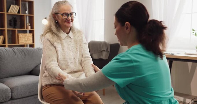 Senior woman and nurse in home physiotherapy. Caregiver guides rehabilitation exercise for mobility, strength. Professional therapy and support aid recovery. Clear physiotherapy concept at home.