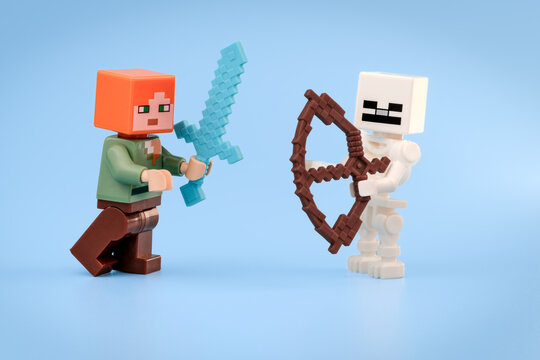 Minecraft Alex holding a Diamond Sword faces a Minecraft Skeleton aiming a brown Bow against a light blue background on Jul 25, 2026 in Jakarta, Indonesia