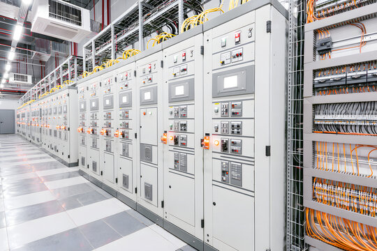 A contemporary electrical control room equipped with rows of distribution panels and wiring