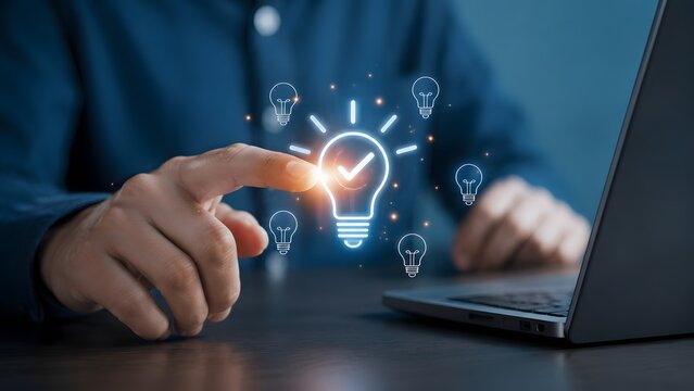 Business solution approval concept showing businessman selecting glowing lightbulb with checkmark icon above laptop for creative strategy success