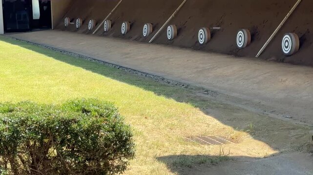 Rows of traditional kyudo archery targets lined up at an outdoor archery range in Japan in summer
