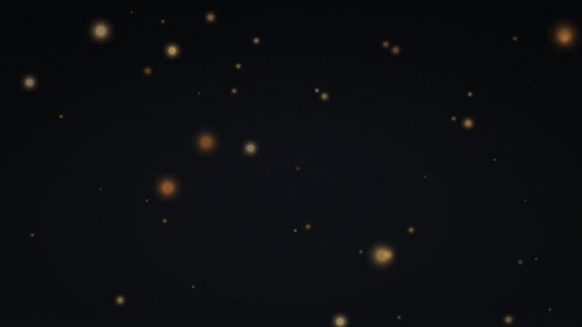 Abstract dark background with shimmering golden light particles floating and sparkling.