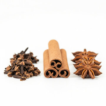 Cinnamon sticks star anise and cloves on white background