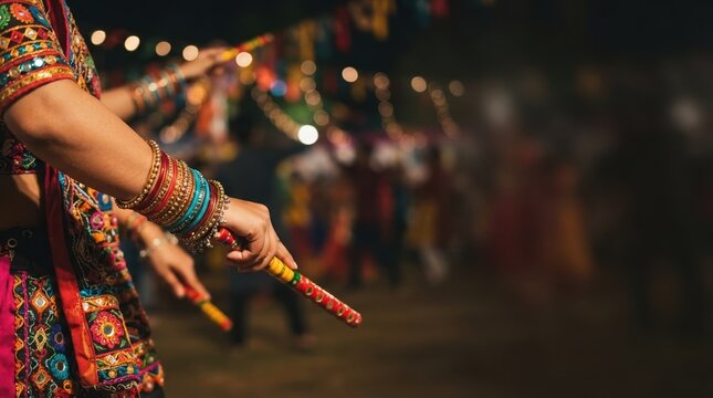 Traditional Indian woman wearing colorful bangles and chaniya choli holding dandiya sticks during Navratri garba dance celebration night festival