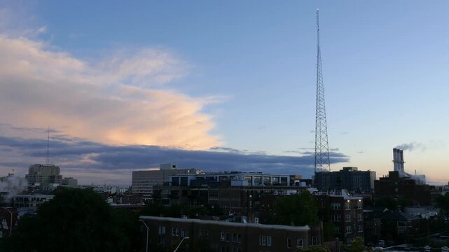 Early morning daybreak dawn view of the Cass Corridor midtown area of Detroit, Michigan. With a large radio antennae and steam from Willis Avenue Station steam utility.