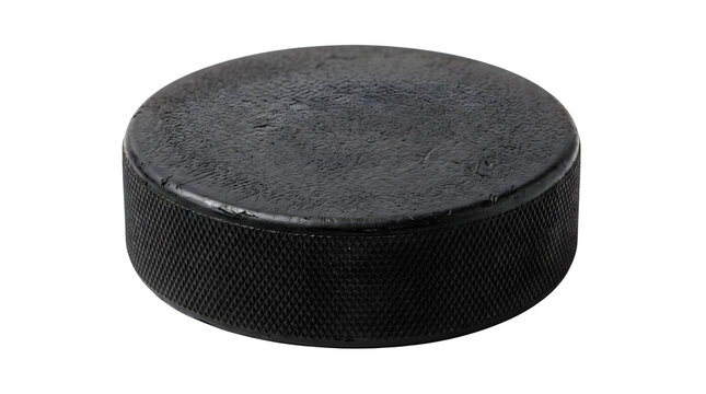 Black ice hockey puck isolated on white background, professional vulcanized rubber hockey puck, textured sports equipment for winter games