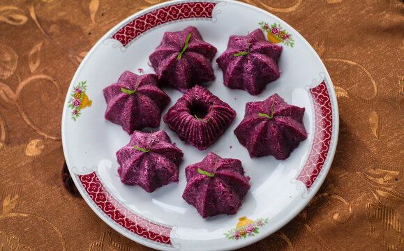 Homemade natural purple sweet potato dessert shaped in star molds, healthy organic Asian snack.