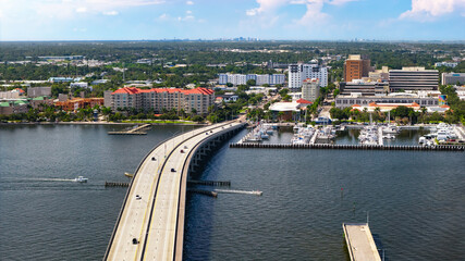 Aerial view of the Green Bridge connecting Palmetto to downtown Bradenton, FL. Vehicles traverse the bridge as recreational boats on the Manatee River head towards Tampa Bay and the Gulf of America. © EyeOfSauron