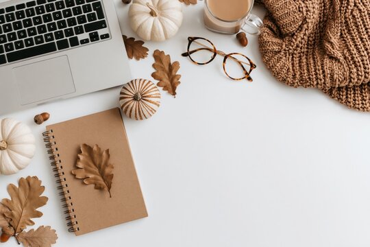 Autumn workspace with laptop notebook pumpkins and oak leaves for a cozy fall desk