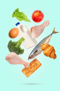 Levitation healthy Food Collection with Fresh Fruits, Vegetables, Dairy, Fish, Bread, and Poultry Isolated on light green Background