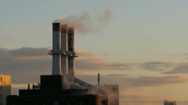 View of Detroit Thermal steam energy utility, historic Willis Avenue Station in Midtown Detroit, Michigan and steam rising from the stacks. Shot during early morning dawn in September 2022.