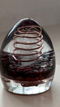 Vertical Video of Rotating Orgone Egg with Black Obsidian Crystals, Handmade Epoxy Resin Crystal Object, Mystical Decorative Design and Spiritual Inspired Concept for Social Media Content