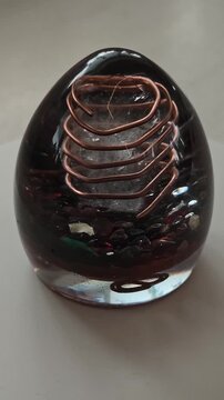 Vertical Video of Rotating Orgone Egg with Black Obsidian Crystals, Handmade Epoxy Resin Crystal Object, Mystical Decorative Design and Spiritual Inspired Concept for Social Media Content