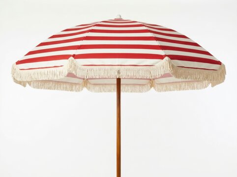 Red and white striped beach umbrella with fringe detail on white background