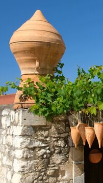 Vertical video of different pottery at the entrance to the local workshop. Crete. Greece.