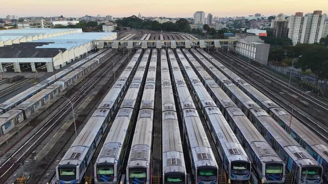 Aerial view of multiple metro trains parked in parallel rows at a railway depot