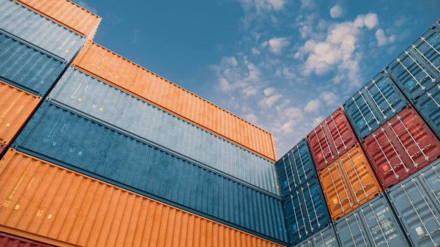 Colorful Shipping Containers Stacked Against Blue Sky