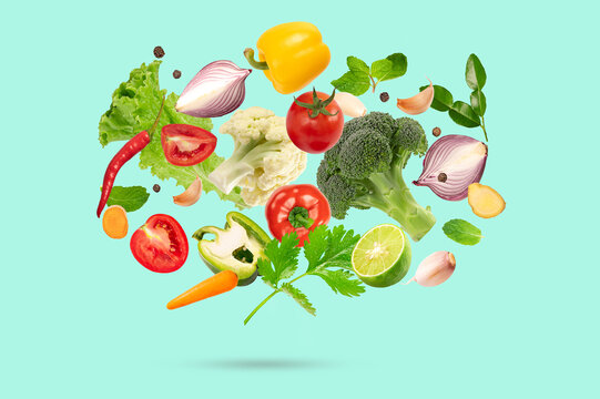 Fresh Vegetable Collection Floating on light green Background with Colorful Organic Ingredients for Healthy Cooking