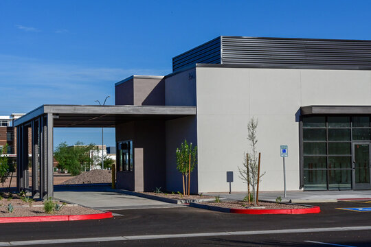 Recently completed commercial building with modern architecture, covered entrance, and landscaped exterior, illustrating commercial real estate and business development