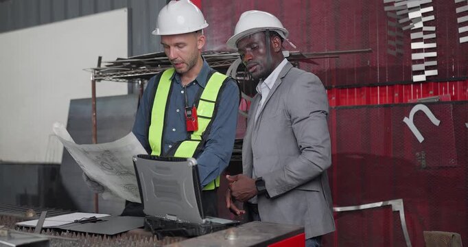 Sales Engineer Briefs Client in QC Workshop on Custom Fabrication Solutions